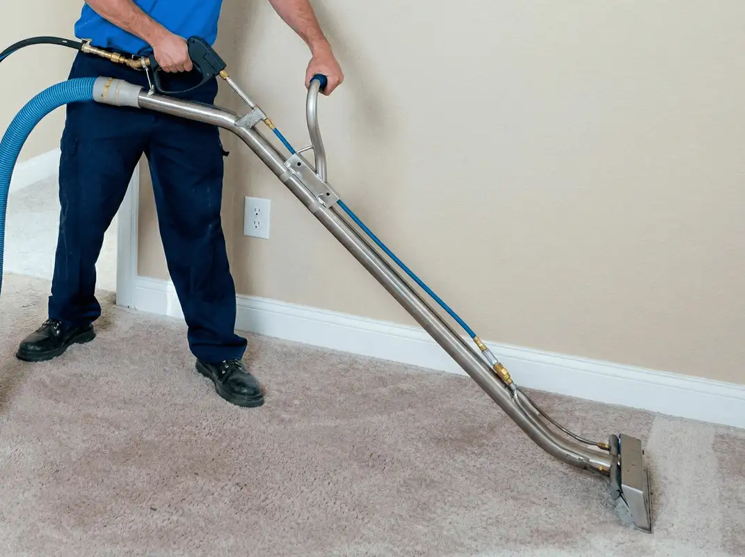 Professional operating a liquid removal machine on a carpeted floor in Duluth, MN